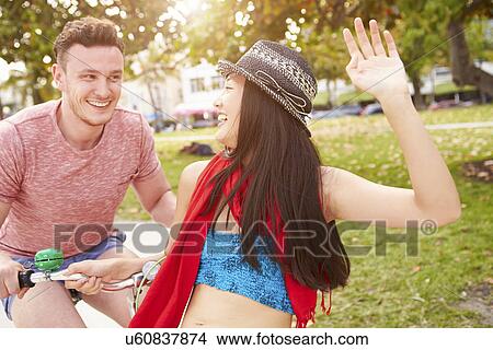 Young Couple Having Fun On Bicycle Ride View Large Photo Image Picture - Young Couple Having Fun On Bicycle Ride. Fotosearch