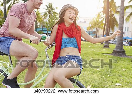 Young Couple Having Fun On Bicycle Ride View Large Photo Image Stock Image - Young Couple Having Fun On Bicycle Ride. Fotosearch