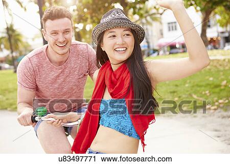 Young Couple Having Fun On Bicycle Ride View Large Photo Image Stock Image - Young Couple Having Fun On Bicycle Ride. Fotosearch