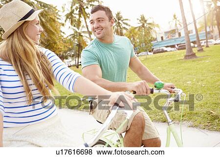 Stock Photo - Young Couple Having Fun On Bicycle Ride. Fotosearch