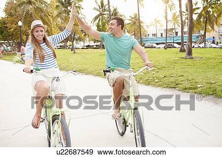 Young Couple Having Fun On Bicycle Ride View Large Photo Image Stock Photo - Young Couple Having Fun On Bicycle Ride. Fotosearch