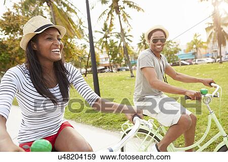 Stock Photo - Young Couple Having Fun On Bicycle Ride. Fotosearch