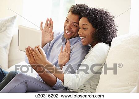 Young Couple Making Video Call Using Digital Tablet View Large Photo Image Stock Image - Young Couple Making Video Call Using Digital Tablet. Fotosearch