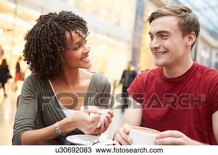 Young Couple Meeting On Date In Cafe View Large Photo Image Stock Image - Young Couple Meeting On Date In Cafe. Fotosearch