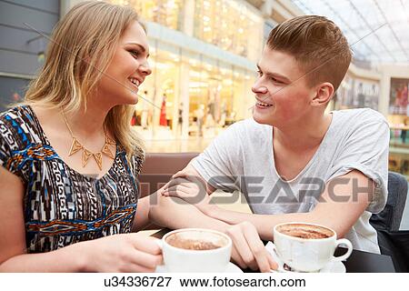 Stock Photo - Young Couple Meeting On Date In Cafe. Fotosearch