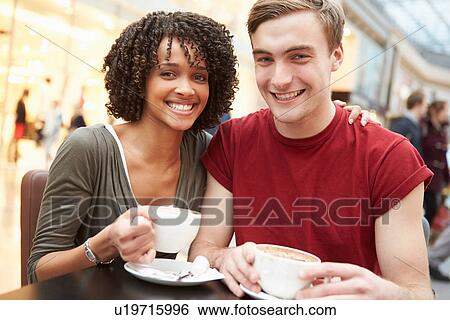 Stock Photograph - Young Couple Meeting On Date In Cafe. Fotosearch