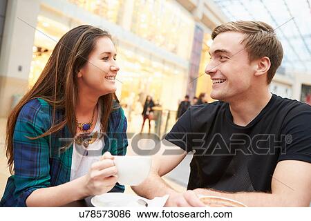Stock Photograph - Young Couple Meeting On Date In Cafe. Fotosearch