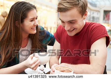 Stock Photography - Young Couple Meeting On Date In Cafe. Fotosearch