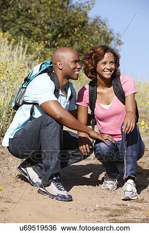 Stock Photograph - Young couple on country hike. Fotosearch