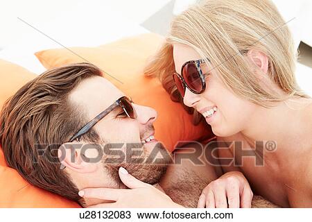 Young Couple On Holiday Relaxing By Swimming Pool View Large Photo Image Stock Image - Young Couple On Holiday Relaxing By Swimming Pool. Fotosearch