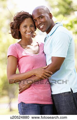 Young couple portrait outdoors View Large Photo Image Stock Image - Young couple portrait outdoors. Fotosearch