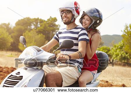 Young Couple Riding Motor Scooter Along Country Road View Large Photo Image Stock Image - Young Couple Riding Motor Scooter Along Country Road. Fotosearch