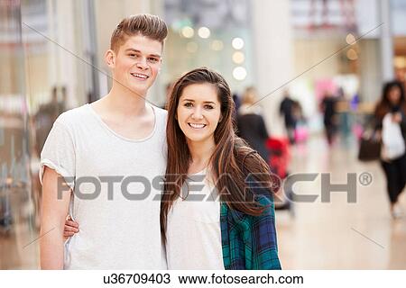 Stock Image - Young Couple Shopping Mall In Mall Together. Fotosearch