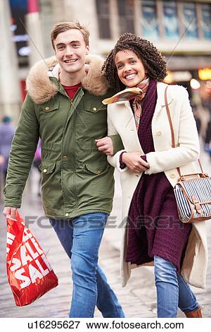 Stock Photo - Young Couple Shopping Outdoors Together. Fotosearch