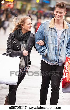 Stock Photo - Young Couple Shopping Outdoors Together. Fotosearch