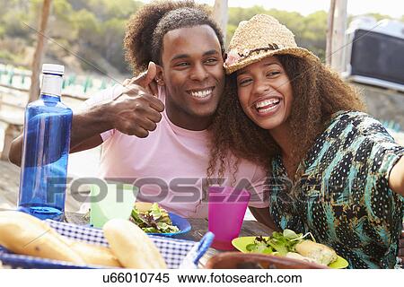 Young Couple Taking Selfie During Lunch Outdoors View Large Photo Image Stock Photography - Young Couple Taking Selfie During Lunch Outdoors. Fotosearch
