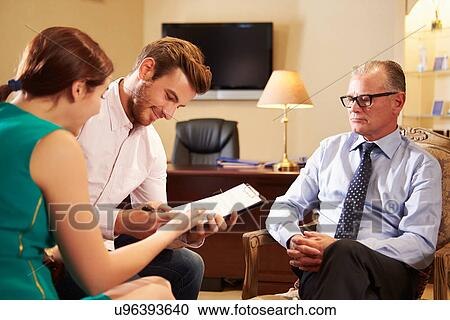 Young Couple Talking To Financial Advisor In Office View Large Photo Image Stock Image - Young Couple Talking To Financial Advisor In Office. Fotosearch