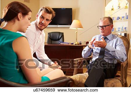 Young Couple Talking To Male Counsellor View Large Photo Image Stock Photo - Young Couple Talking To Male Counsellor. Fotosearch