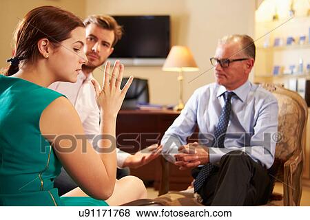 Young Couple Talking To Male Counsellor View Large Photo Image Stock Photo - Young Couple Talking To Male Counsellor. Fotosearch