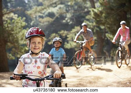 Stock Image - Young family on country bike ride. Fotosearch