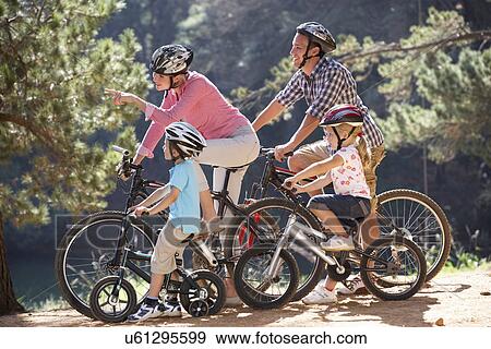 Stock Photo - Young family on country bike ride. Fotosearch