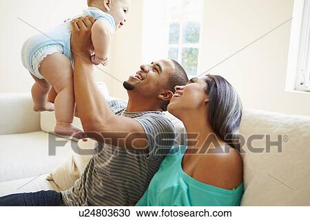 Young Family Playing With Happy Baby Son At Home View Large Photo Image Stock Image - Young Family Playing With Happy Baby Son At Home. Fotosearch