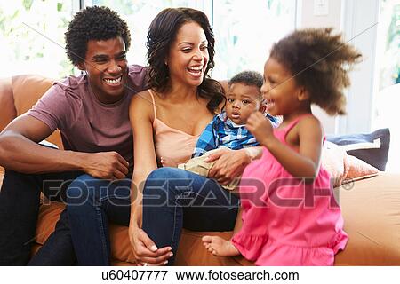 Young Family Relaxing On Sofa Together View Large Photo Image Stock Photo - Young Family Relaxing On Sofa Together. Fotosearch
