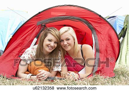Stock Photo - Young friends on camping trip. Fotosearch