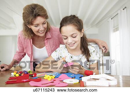Young girl doing handicrafts with grandmother View Large Photo Image Stock Image - Young girl doing handicrafts with grandmother. Fotosearch