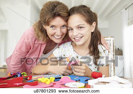 Young girl doing handicrafts with grandmother View Large Photo Image Stock Image - Young girl doing handicrafts with grandmother. Fotosearch