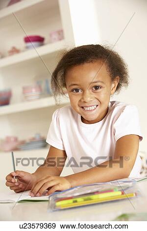 Young girl drawing at home View Large Photo Image Stock Photo - Young girl drawing at home. Fotosearch