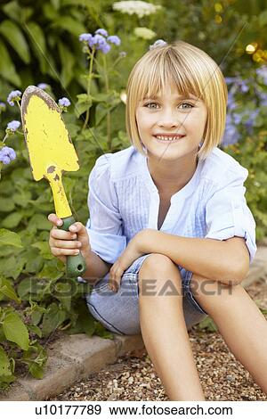 Stock Photo - Young girl gardening. Fotosearch