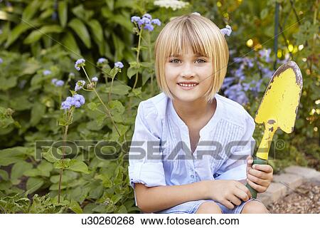 Stock Photo - Young girl gardening. Fotosearch