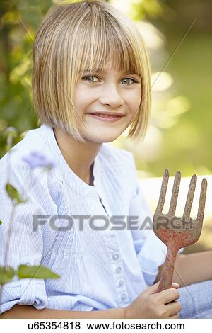 Young girl gardening View Large Photo Image Stock Photo - Young girl gardening. Fotosearch