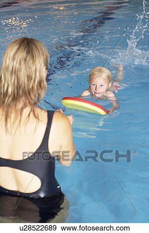 Stock Photo - Young girl learning to swim. Fotosearch