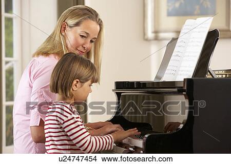 Young girl playing piano in music lesson View Large Photo Image Picture - Young girl playing piano in music lesson. Fotosearch