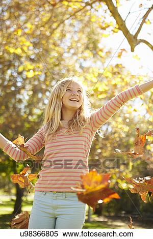Young Girl Throwing Autumn Leaves In The Air View Large Photo Image Stock Photography - Young Girl Throwing Autumn Leaves In The Air. Fotosearch