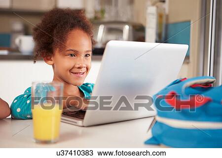 Young Girl Using Laptop To Do Homework At Table View Large Photo Image Stock Image - Young Girl Using Laptop To Do Homework At Table. Fotosearch