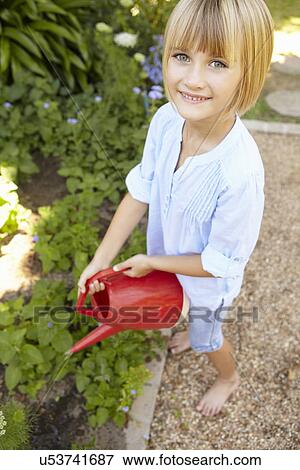 Stock Photo - Young girl watering garden. Fotosearch