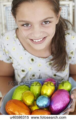 Stock Photography - Young girl with Easter eggs. Fotosearch
