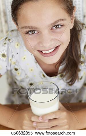 Stock Photography - Young girl with milk. Fotosearch