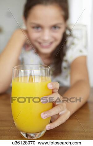 Young girl with orange juice View Large Photo Image Stock Image - Young girl with orange juice. Fotosearch