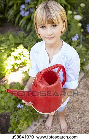 Young girl with watering can View Large Photo Image Stock Image - Young girl with watering can. Fotosearch