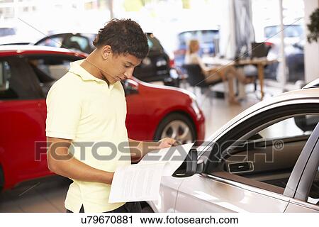 Young man buying new car View Large Photo Image Stock Image - Young man buying new car. Fotosearch