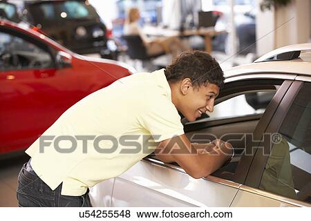 Young man buying new car View Large Photo Image Stock Photo - Young man buying new car. Fotosearch