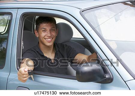 Young man in car View Large Photo Image Stock Image - Young man in car. Fotosearch