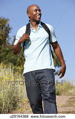Young man on country hike View Large Photo Image Stock Photo - Young man on country hike. Fotosearch