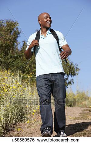Young man on country hike View Large Photo Image Stock Photograph - Young man on country hike. Fotosearch