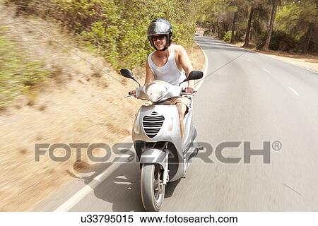 Young Man Riding Motor Scooter Along Country Road View Large Photo Image Stock Photography - Young Man Riding Motor Scooter Along Country Road. Fotosearch