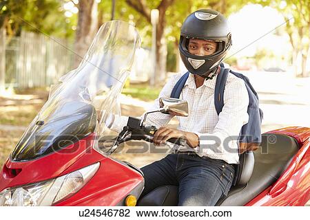 Stock Image - Young Man Riding Motor Scooter To Work. Fotosearch